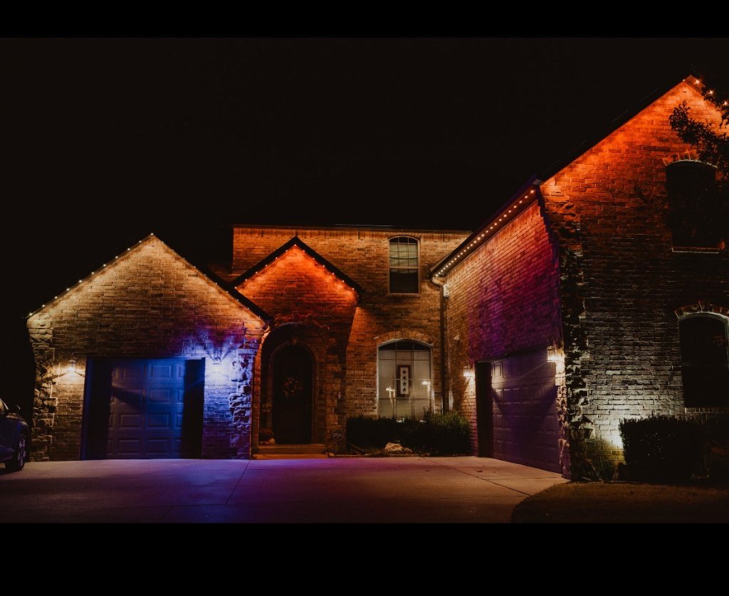 Homeowner-controlled exterior lighting shown across a home facade
