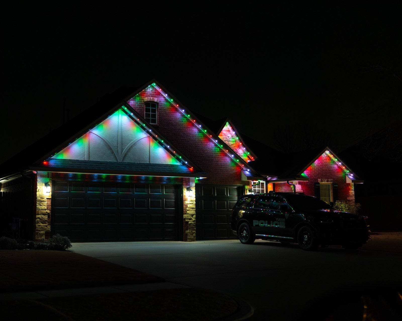 Home with permanent holiday lighting in full color along the roofline